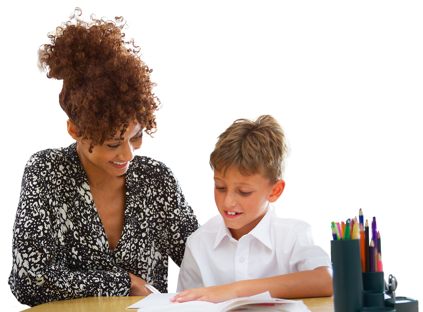 A woman helping a boy with an activity