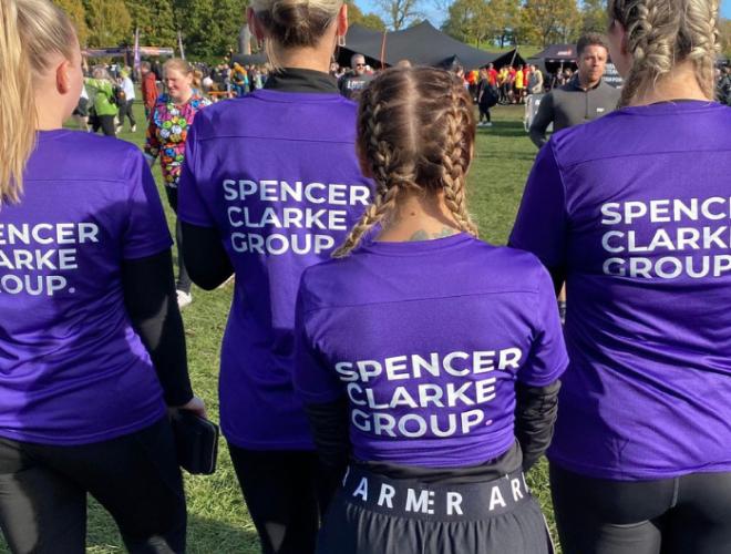 A group outside wearing Spencer Clarke Group apparel